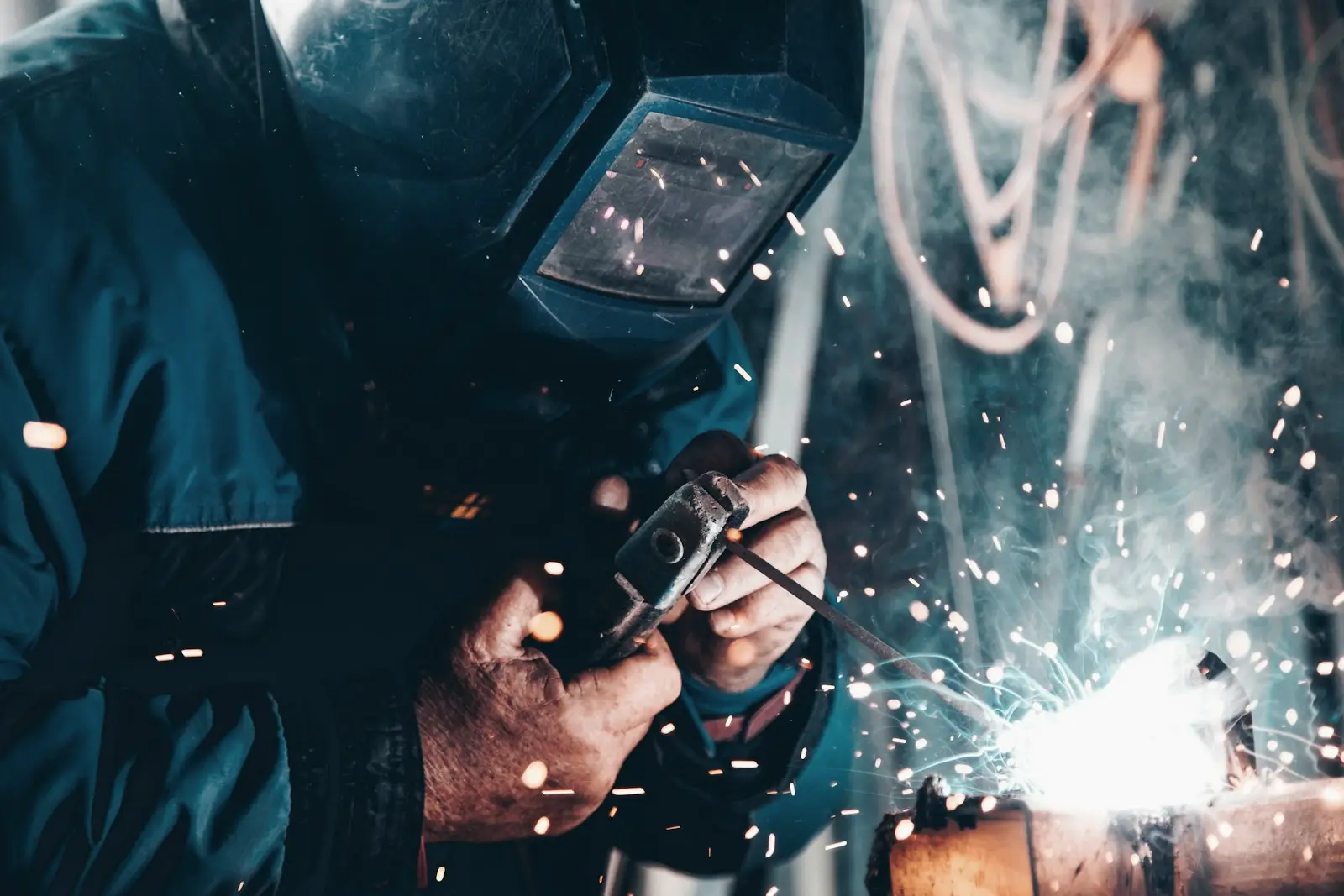 Welder at work on a production floor